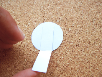 glue the tab to the ball. Align it to the bottom of the ball so it can sit on the sand